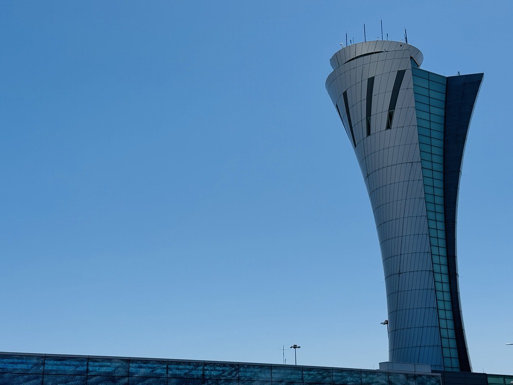 Airport control tower where AI air traffic control systems monitor runway arrivals