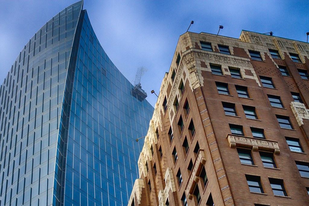 Modern glass office tower where AI predicts elevator breakdowns through predictive maintenance