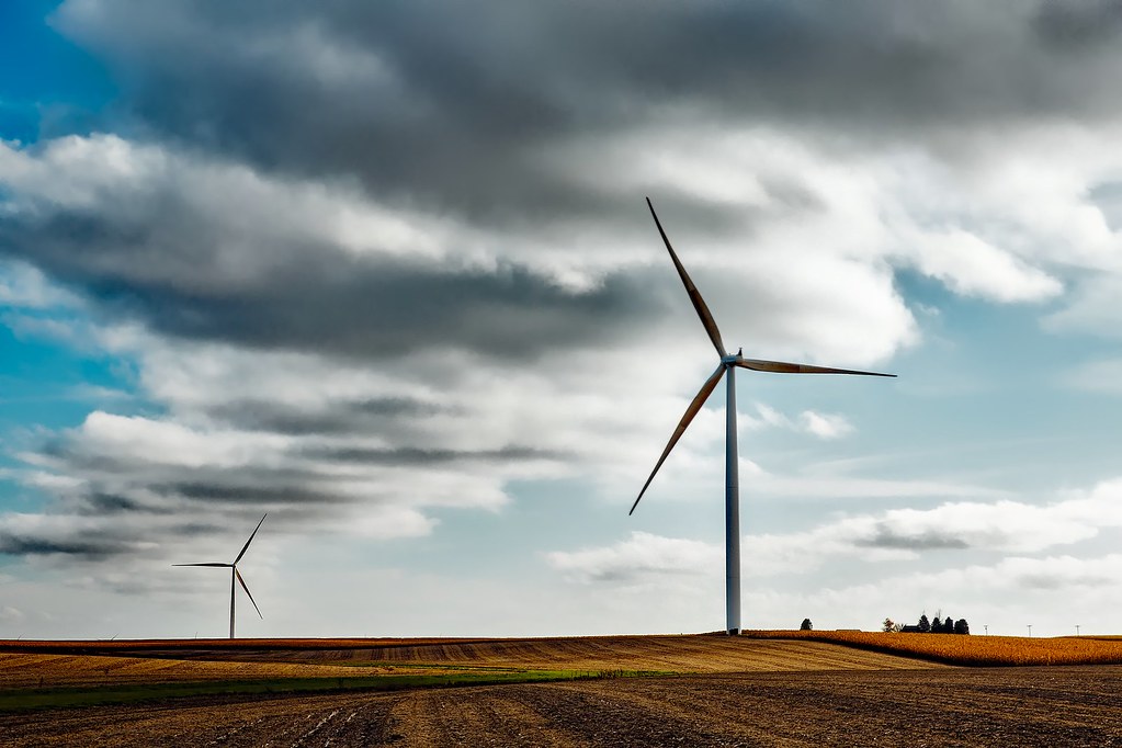 Wind turbine farm at sunset illustrating AI wind power forecasting for the electricity grid