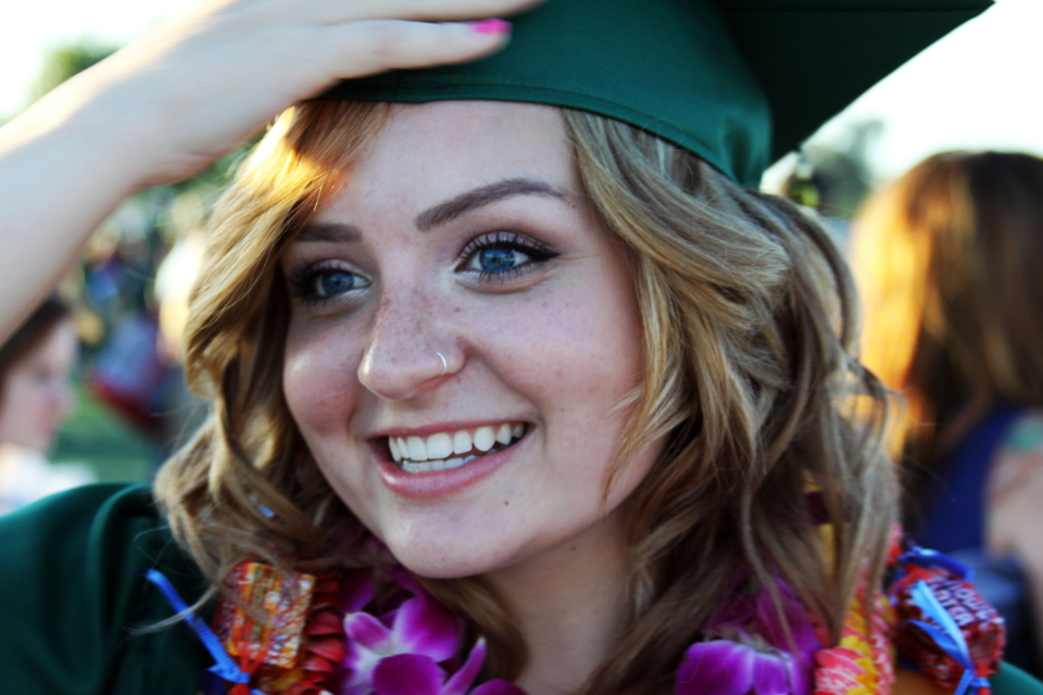 College graduate in cap and gown, BCA vs B.Com education comparison