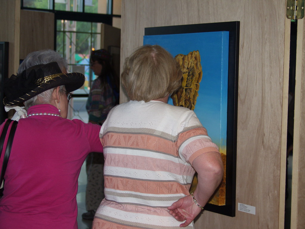 Framed artworks displayed on a wall at a juried art exhibition, illustrating rules for AI art in contests