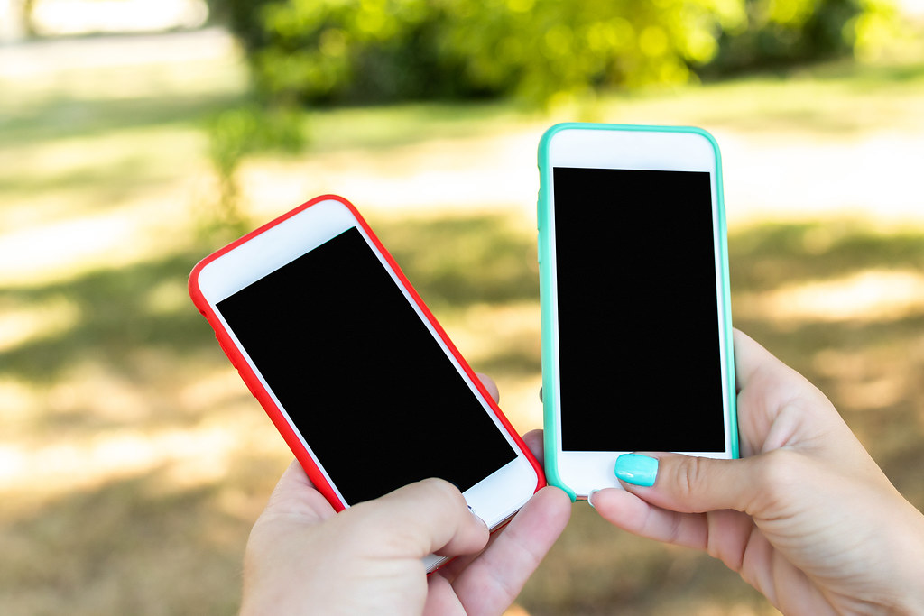 Two smartphones with blank screens, illustrating ChatGPT teen mode and age prediction