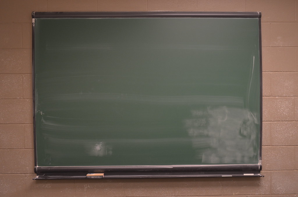 Empty classroom chalkboard illustrating the AI math proof that disproved an 80-year-old Erdos conjecture