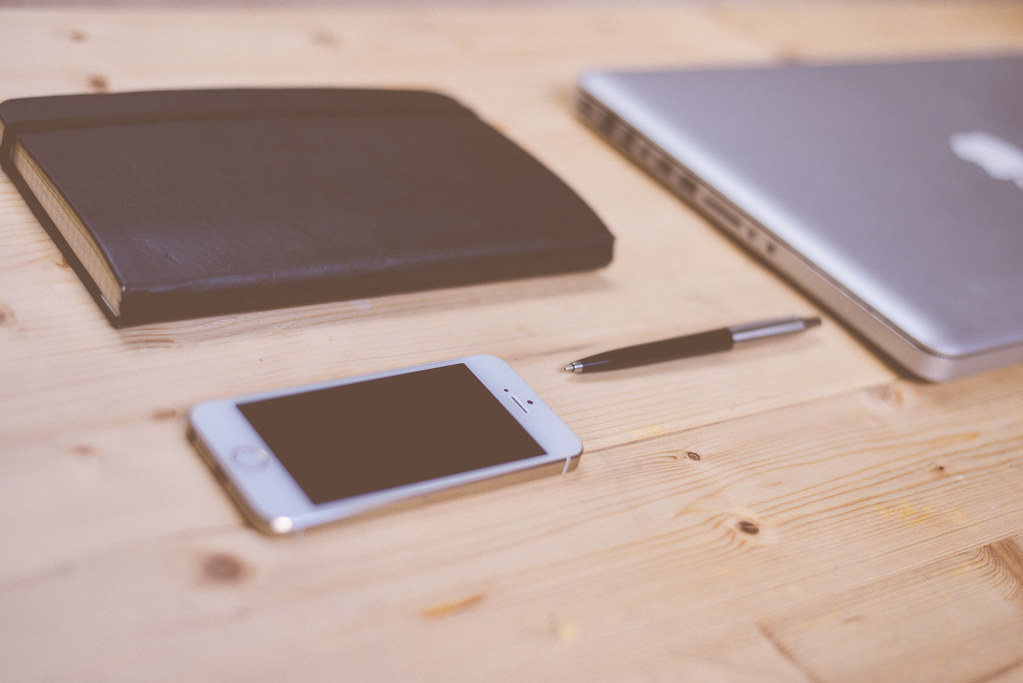 iPhone on a desk, illustrating whether Google sees what you ask Siri