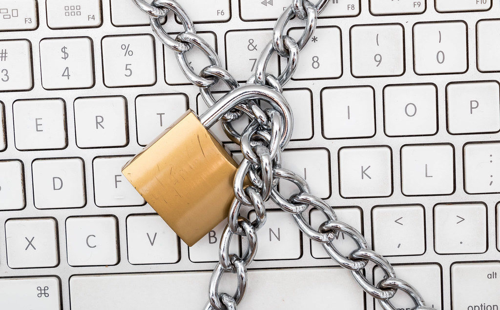 Padlock and chains on a keyboard, illustrating how Gemini hacked three companies using leaked and guessed passwords